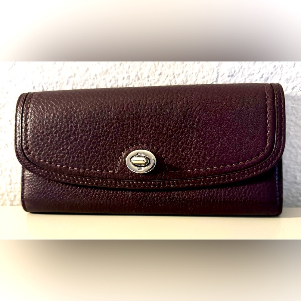 Gently used purple Coach wallet with silver hardware.